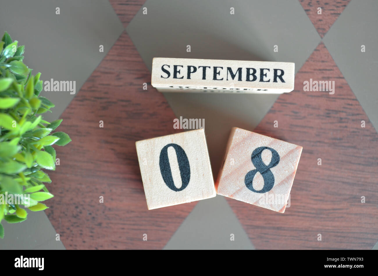 Date of September with leaf on diamond pattern table for background ...