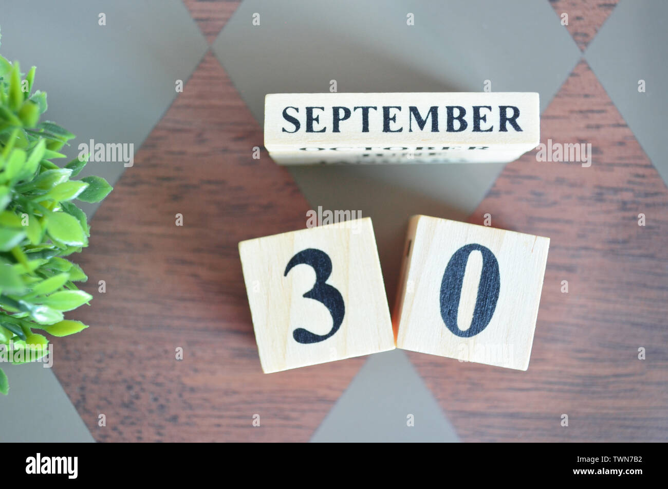 Date of September with leaf on diamond pattern table for background ...