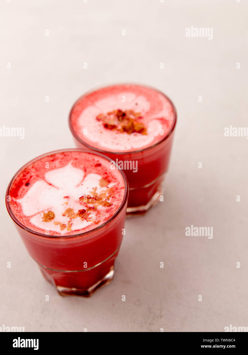 Two Beetroot latte on white background. It is flower pastel on the top of the latter Stock Photo