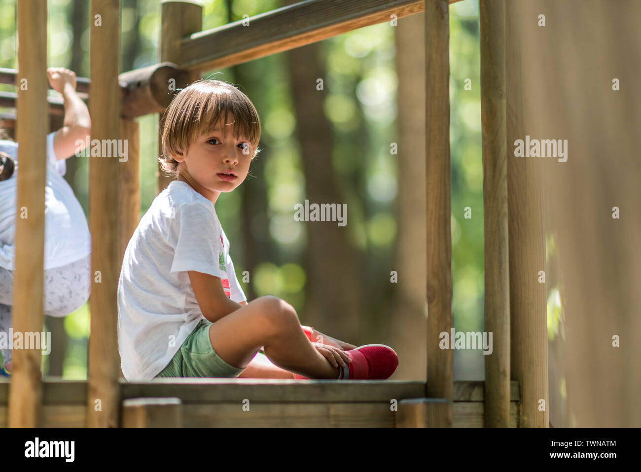 Beautiful face, gentle eyes. The boy in the picture takes a break from the play to be careful in front of the photo camera and to rest for a few momen Stock Photo