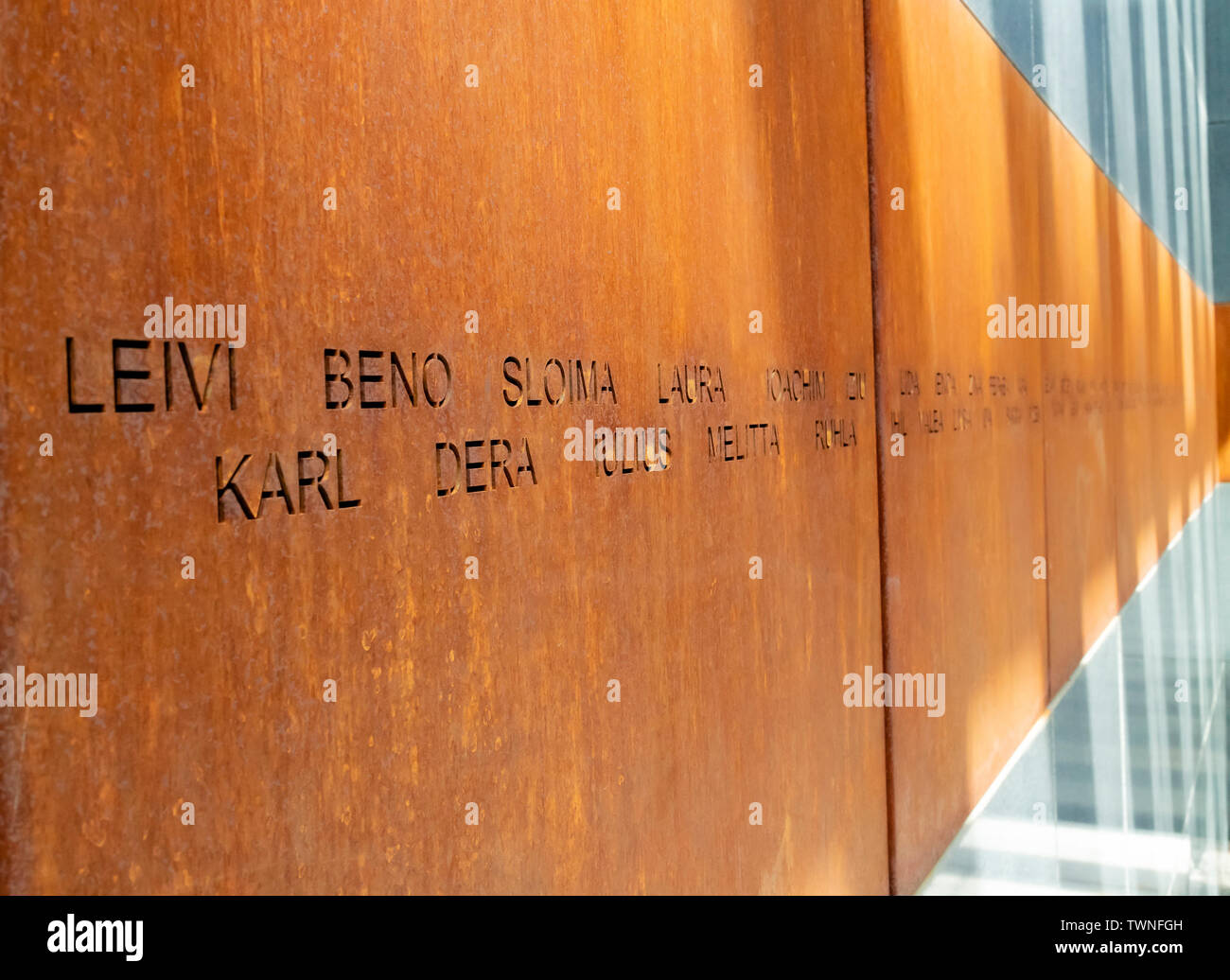 Bucharest, Romania - August 13th, 2018: Victims names written on rusty metal walls in the holocaust memorial in Bucharest, Romania Stock Photo