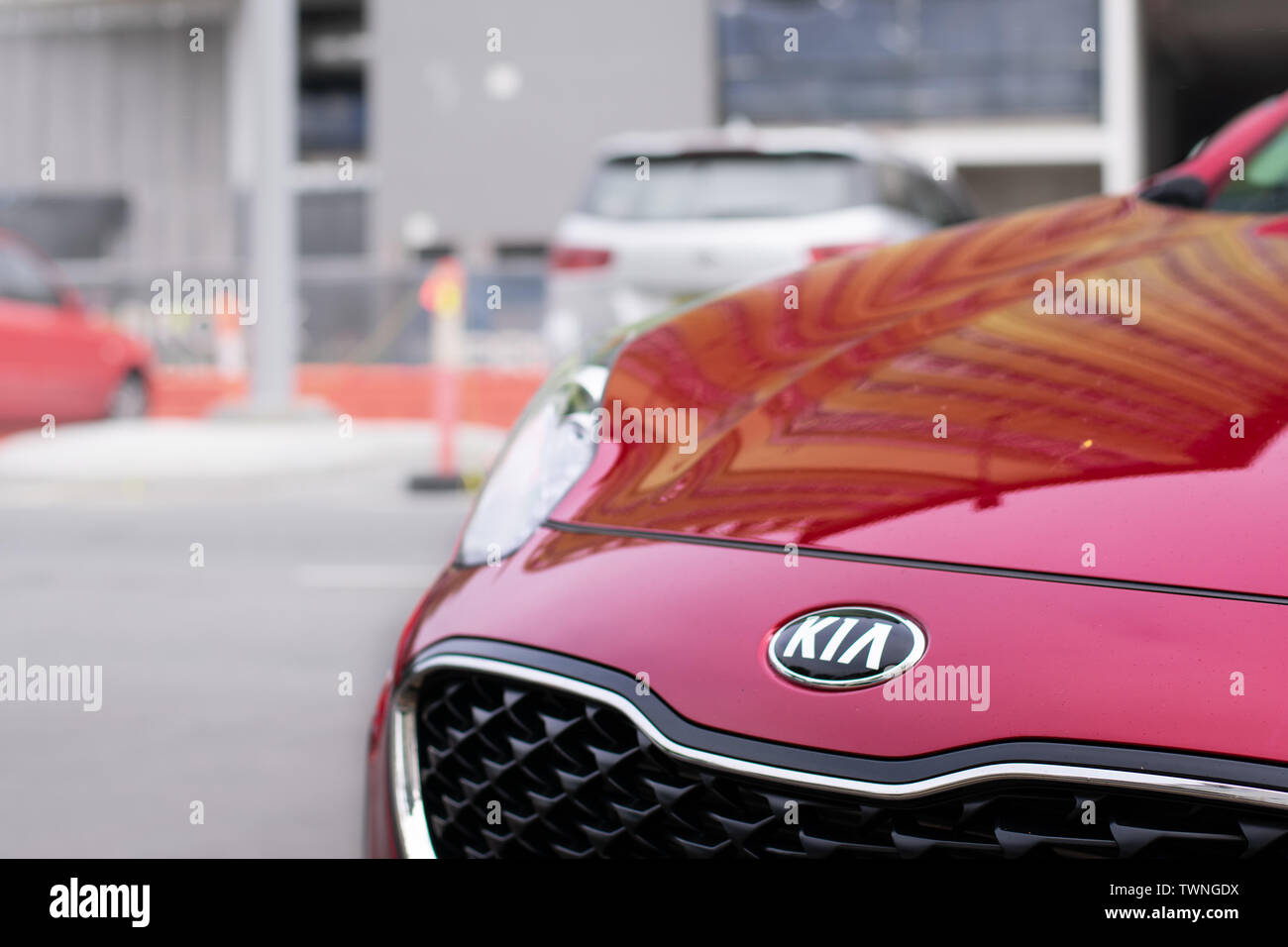 Kia logo on red car in the city Stock Photo