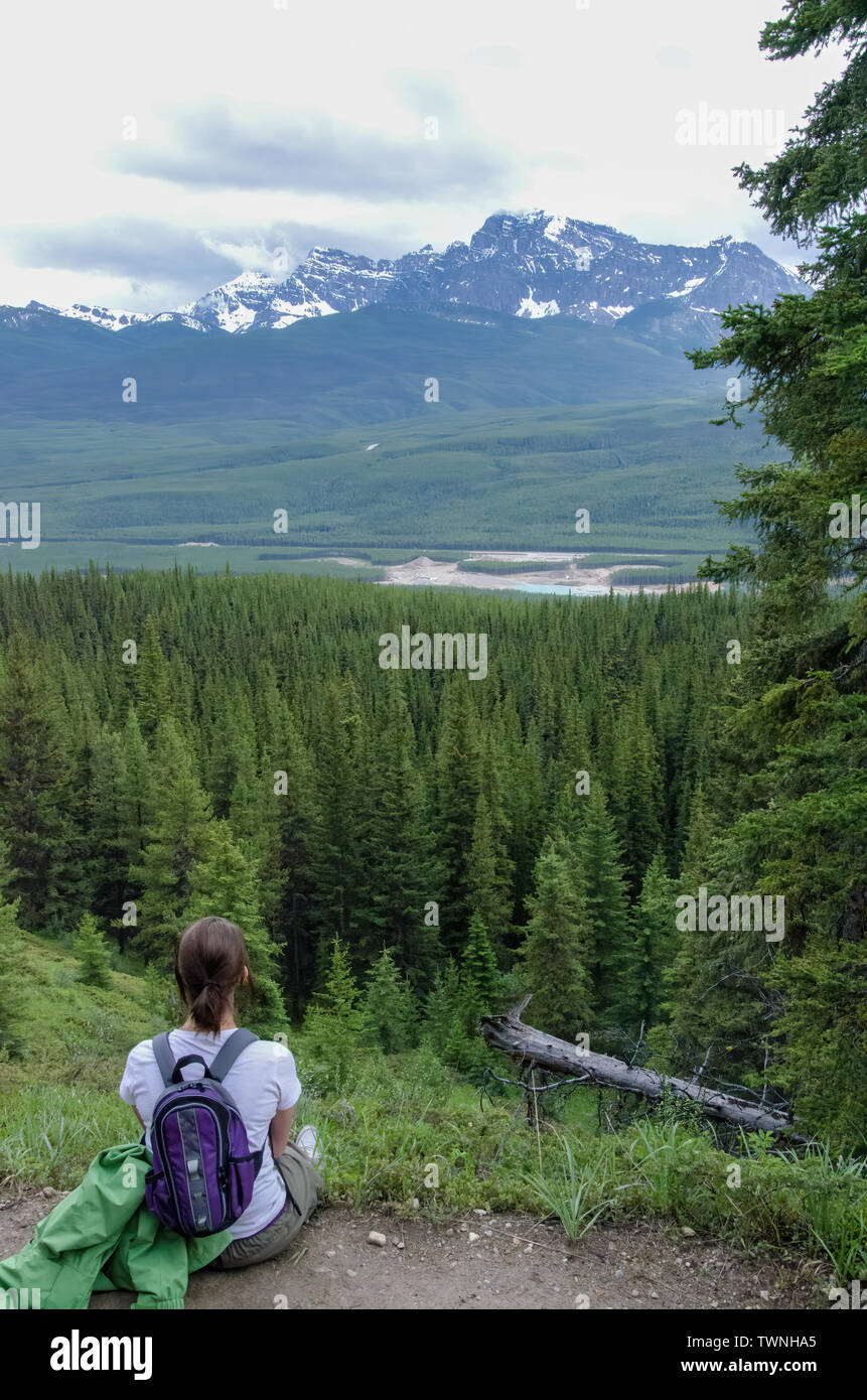girl looking at the view on top of a mountain in Canada Stock Photo