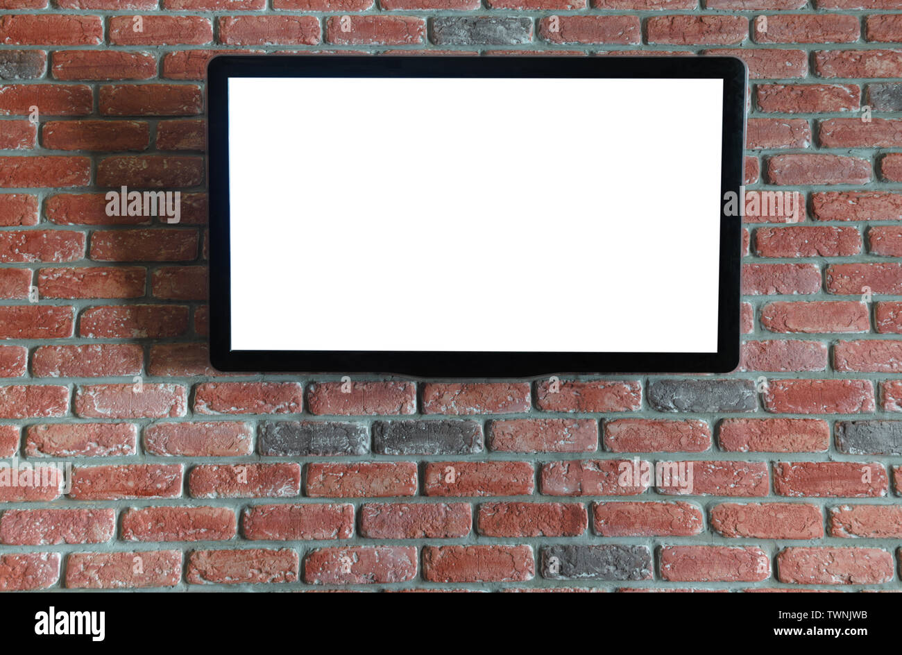 TV on the red brick wall with isolated screen Stock Photo