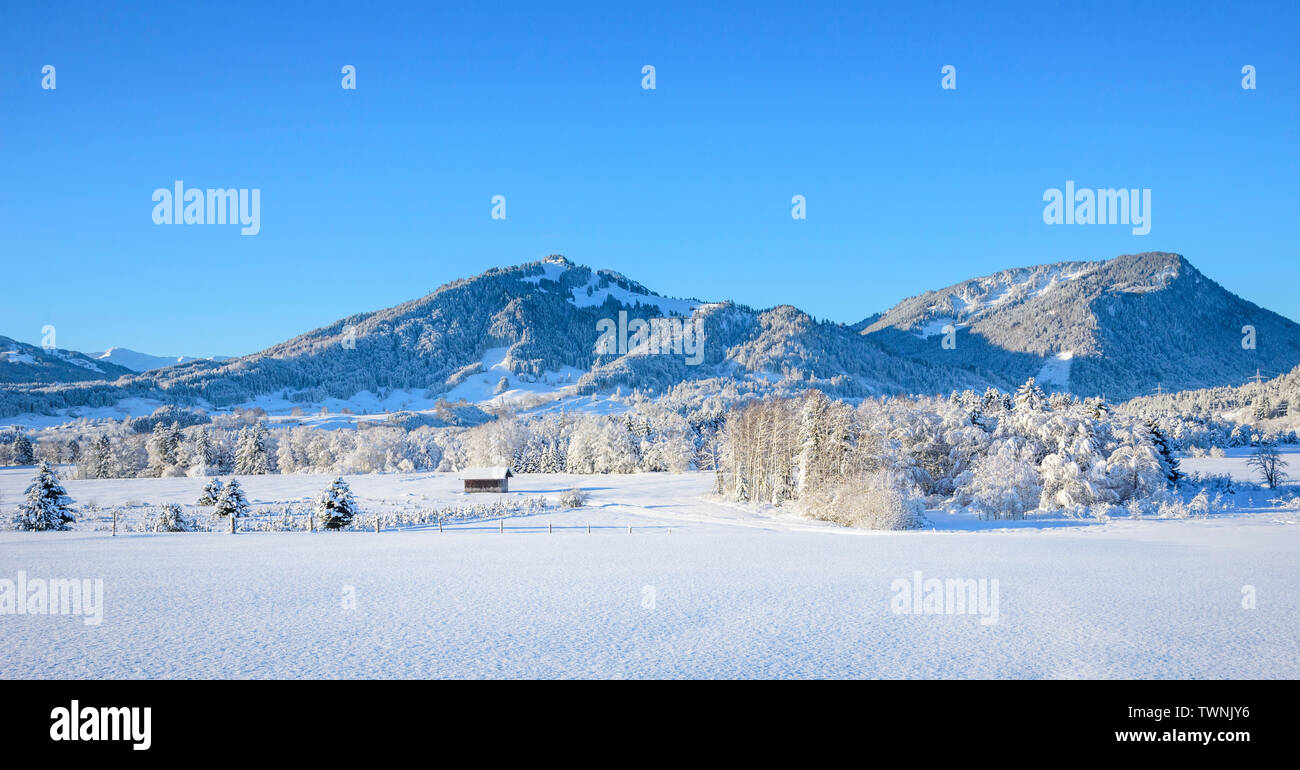 Peaceful morning scenery at a cold and cloudless winter day in bavarian Allgäu Stock Photo