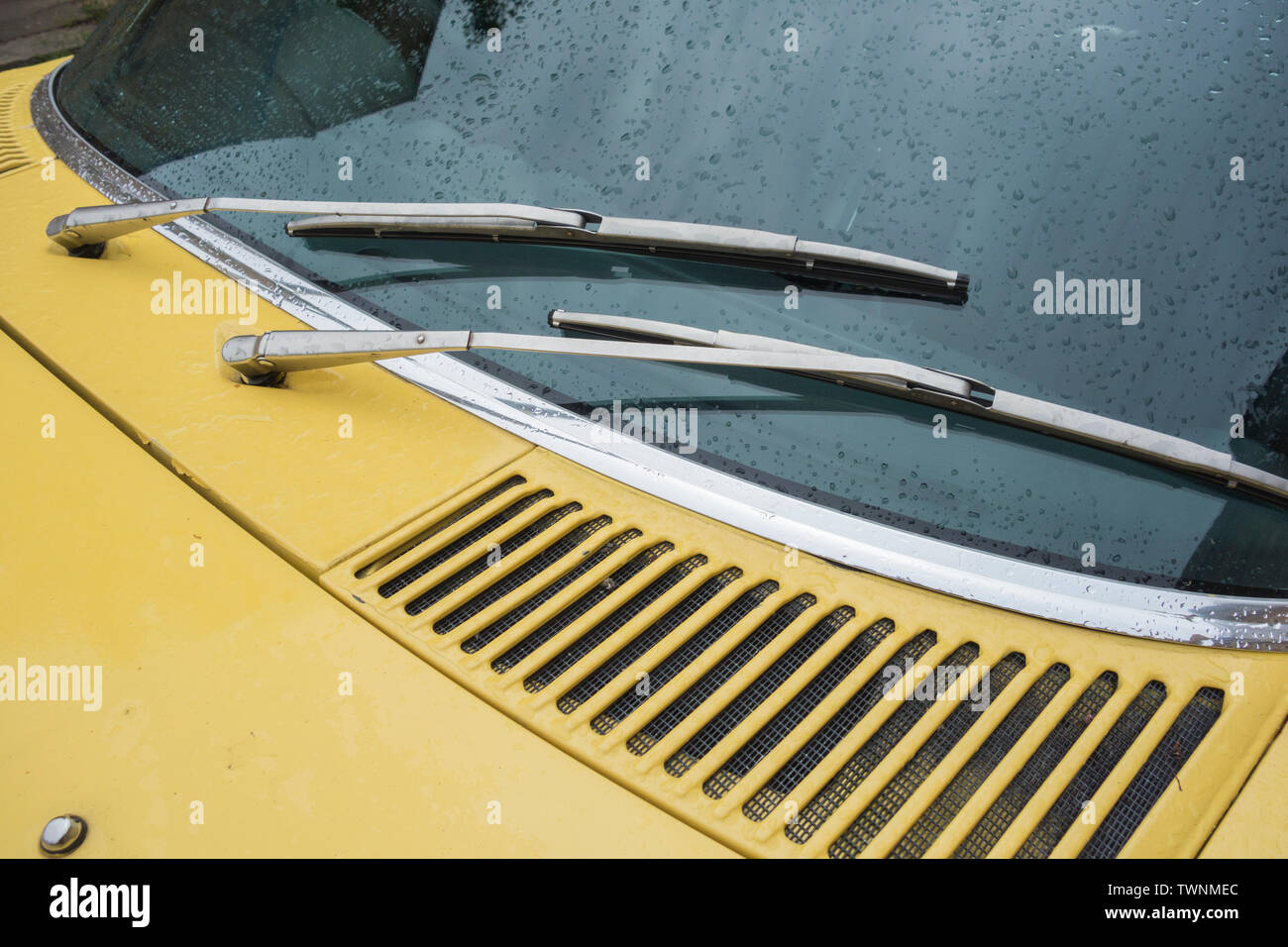 Close-up of windscreen and window wipers on a yellow Mercedes Benz 350 SL classic car Stock Photo