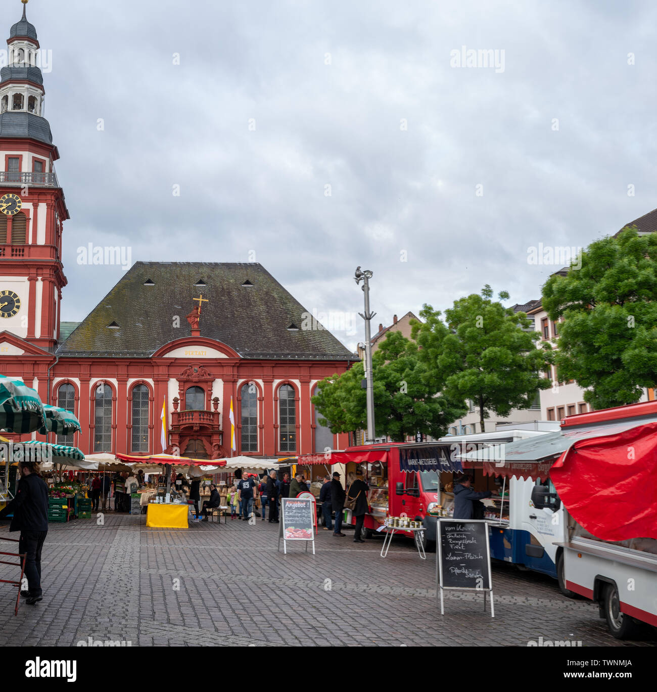 MANNHEIM, GERMANY, 05/11/2019: market square with stands in front of the town hall on a rainy day Stock Photo