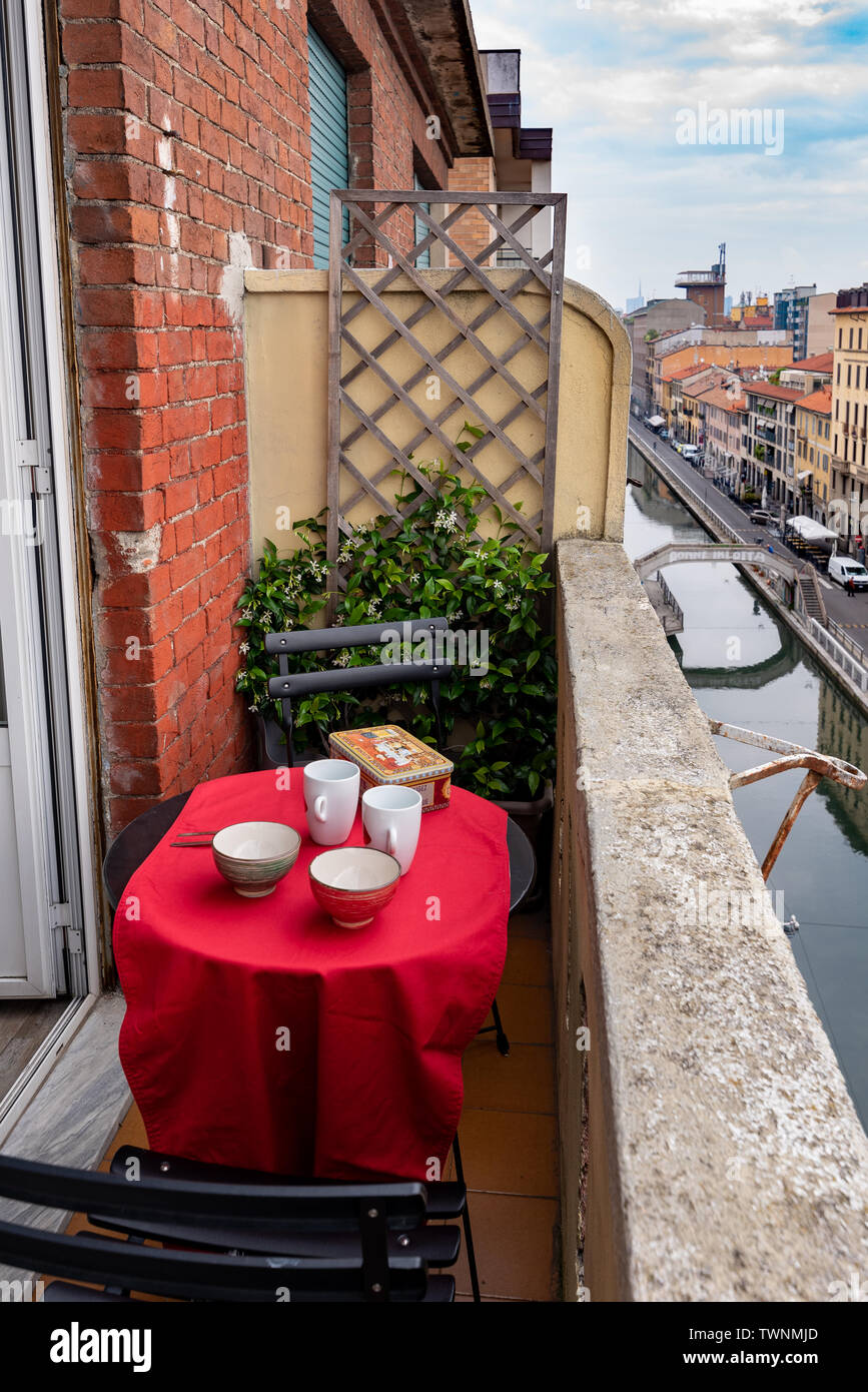 small table on a balcony, set for breakfast with cups and sweeties box Stock Photo