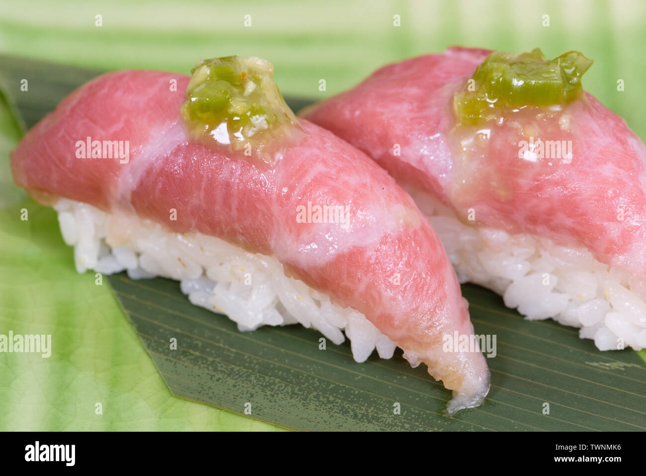 nigiri of raw beef Kobe beef with green sauce, macro details Stock Photo