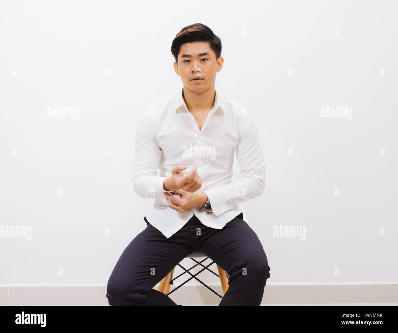 Man sitting chair studio shot hi-res stock photography and images - Alamy