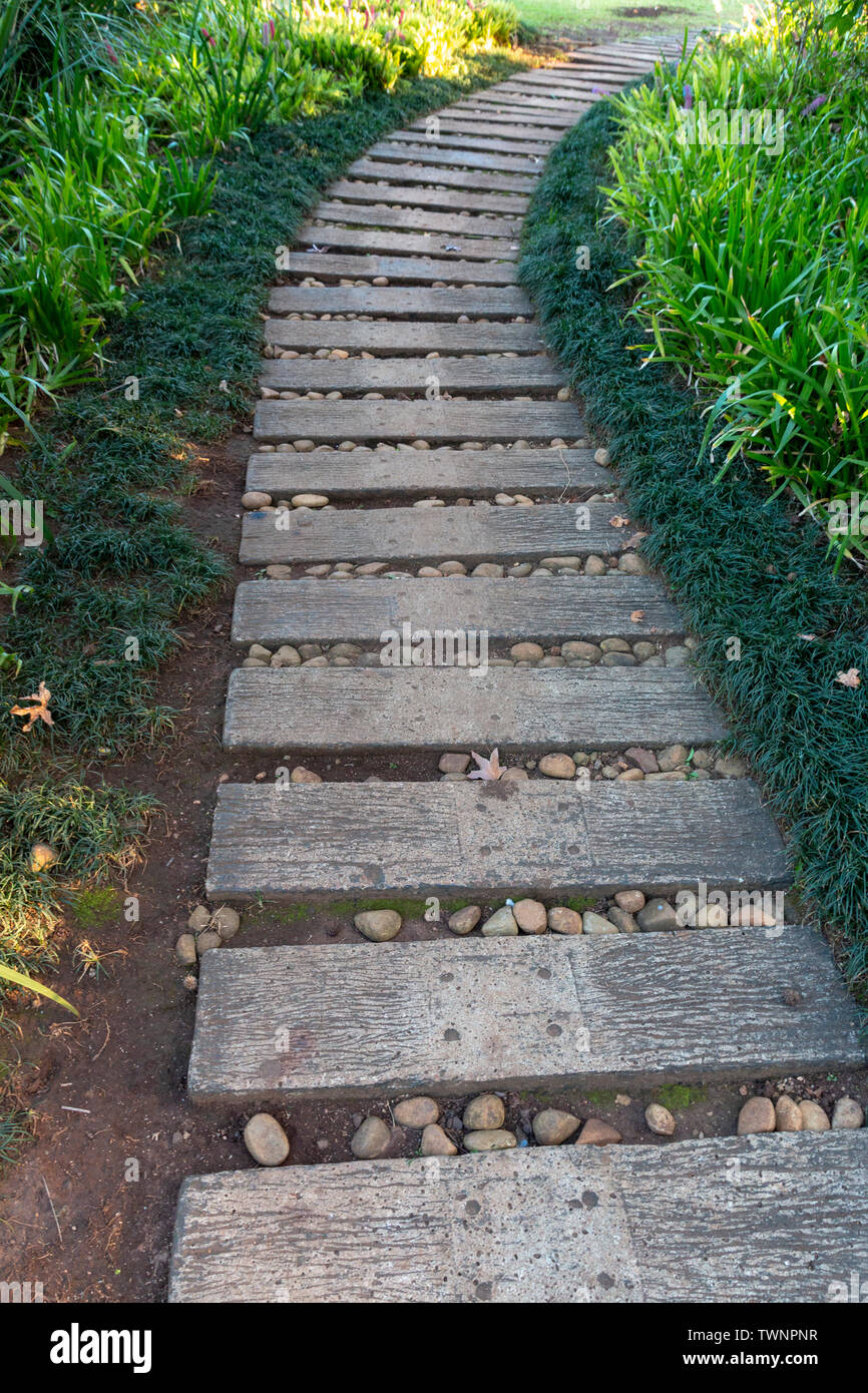 A close up view of a path make from sleepers in and outdoor garden Stock Photo
