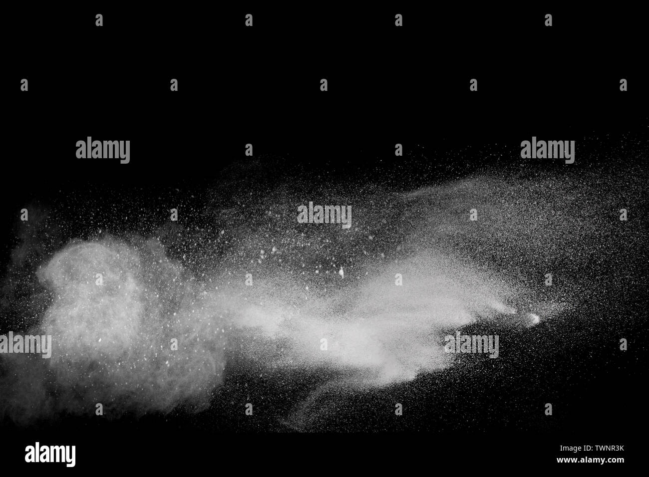 Freeze motion explosion of white powder on a black background.Stopping ...