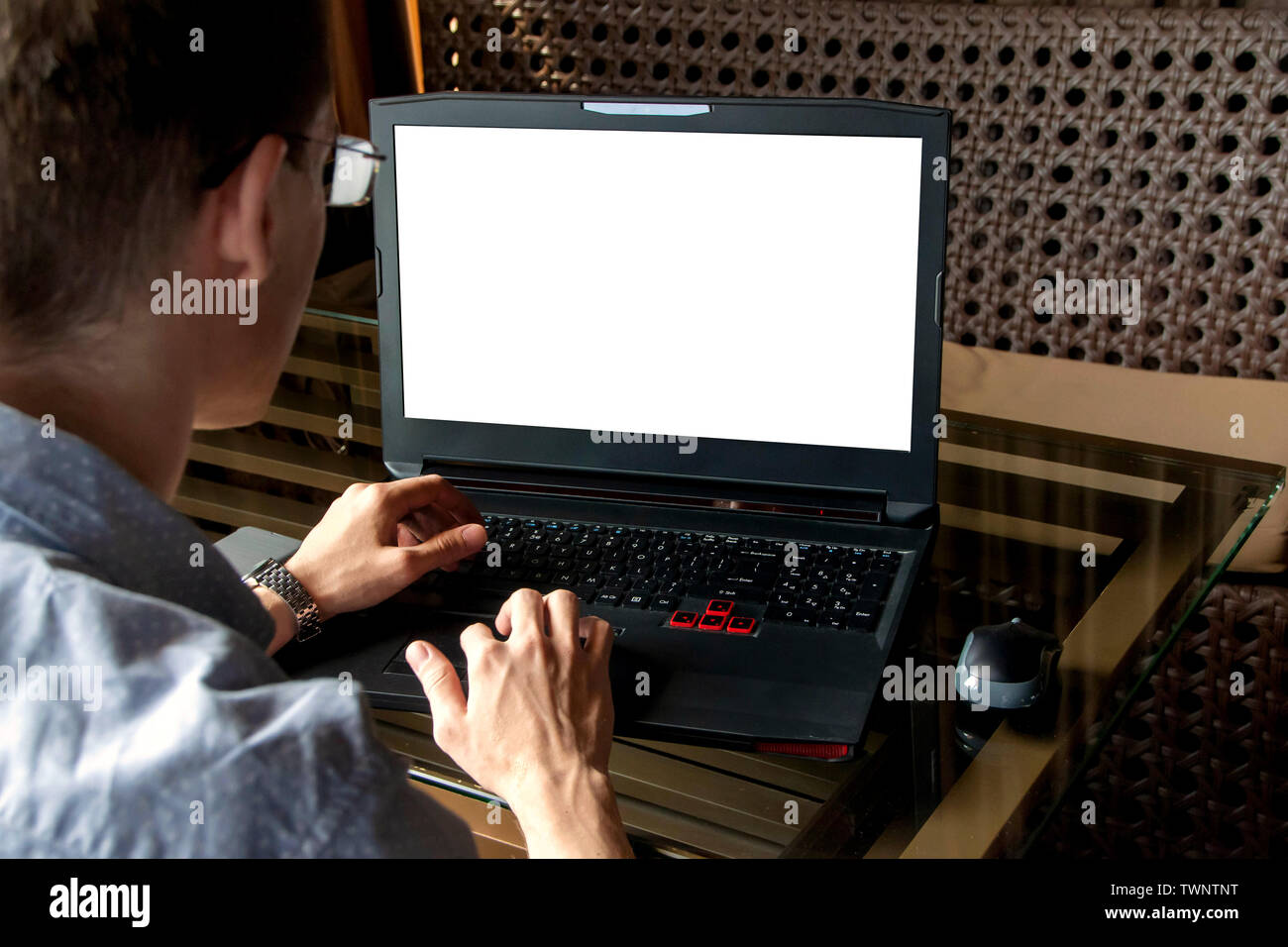 Man working on his laptop with mobile phone Stock Photo