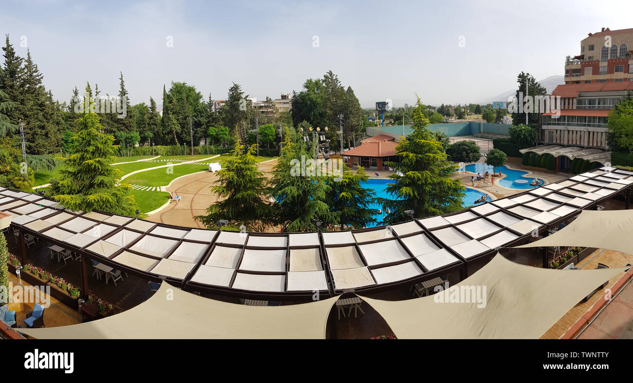 The garden and the pool of the Chtaura Park Hotel. Beqaa Valley, Lebanon - June, 2019 Stock Photo