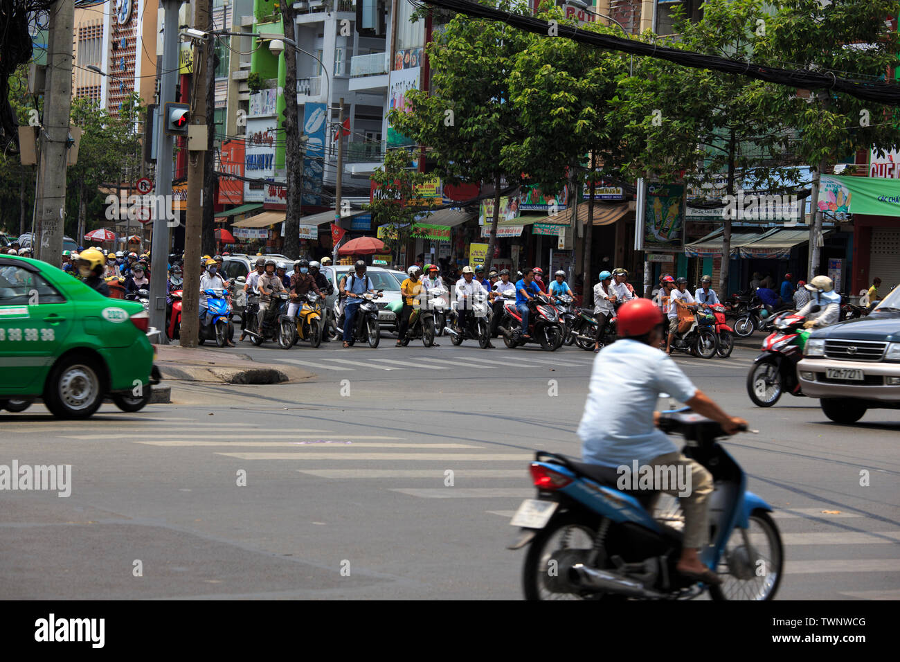 Saigon, Vietnam - April 21, 2014: Chaotic road traffic in Saigon, Vietnam. In the biggest city in Southern Vietnam are more than 4 mil. motorbikes, th Stock Photo