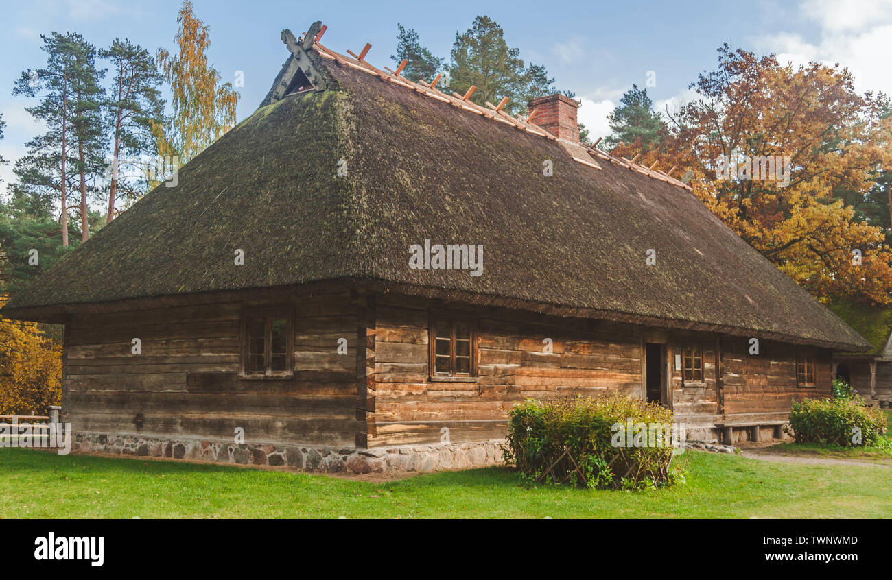 Autumn scene of Latvian traditional wooden dwelling house in the Ethnographic Open-Air Museum of Latvia. Stock Photo
