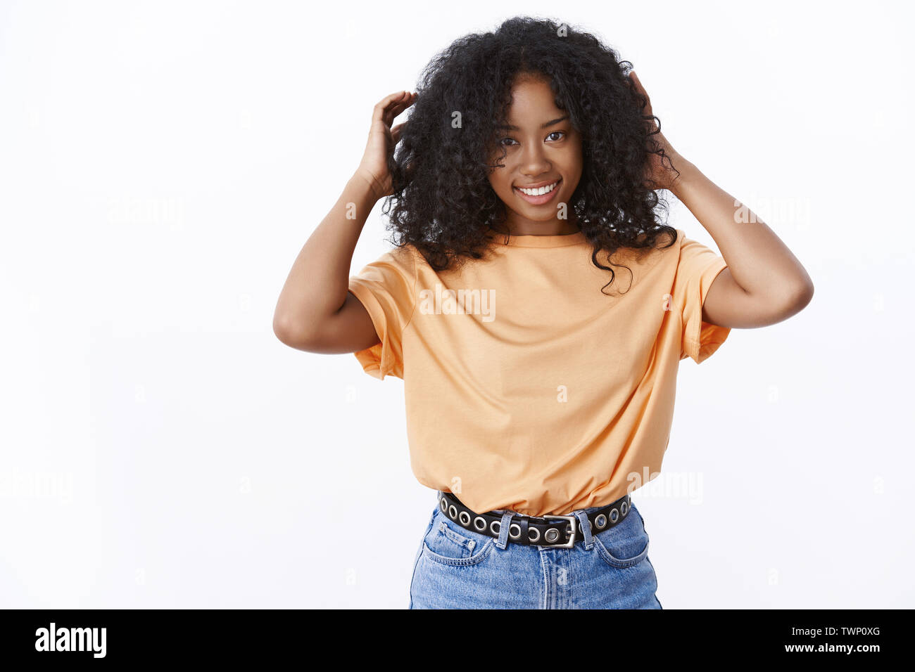 Attractive Smiling African American Young Woman Touching Curly