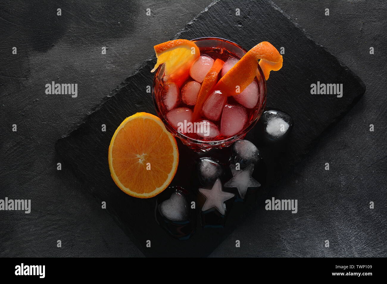 Negroni cocktail. Smoky Italian aperitif with gin, campari, martini Rosso, orange and ice cubes