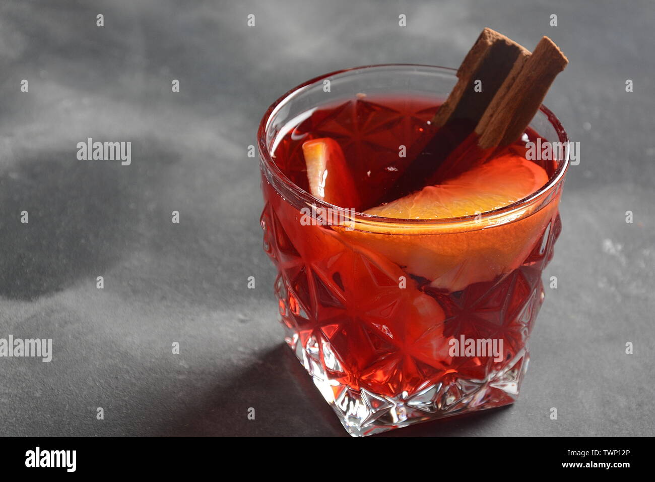 Negroni cocktail. Smoky Italian aperitif with gin, campari, martini Rosso, orange and ice cubes