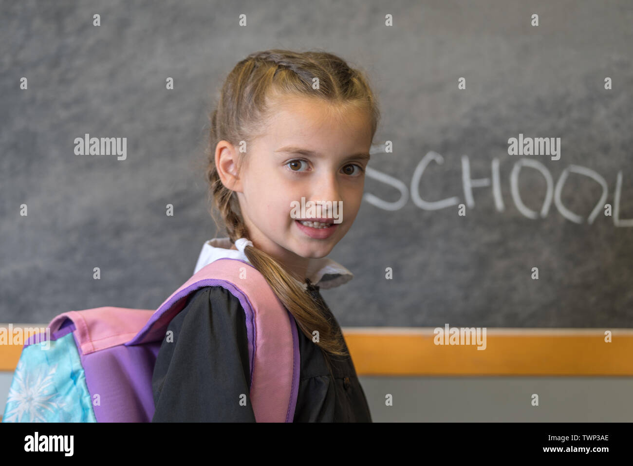 Elementary school student posing in uniform in a class setting Stock
