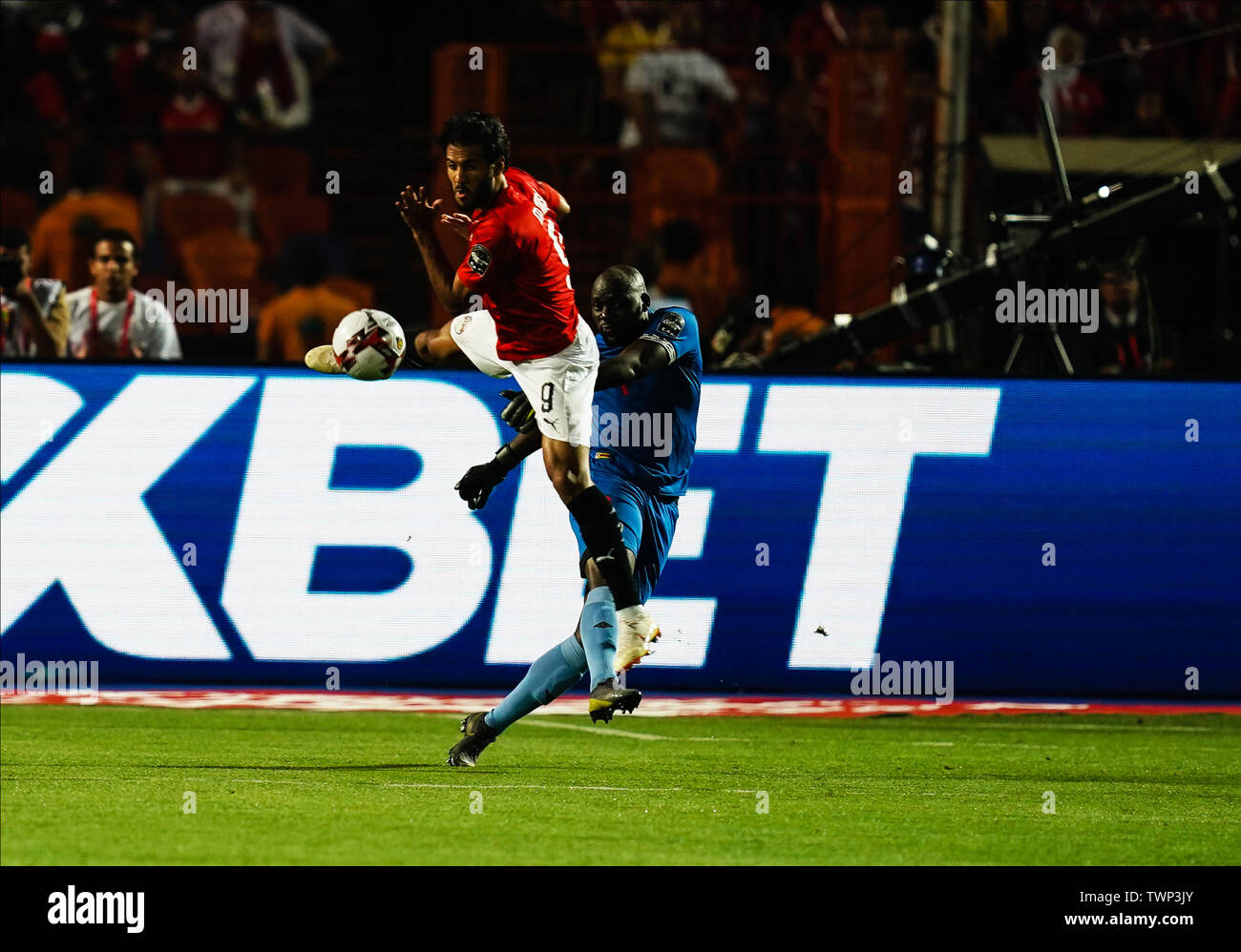 Cairo, Egypt. 21st June, 2019. Edmore Sibanda of Zimbabwe clearing the ball in front of Marwan Mohsen Fahmy Tharwat of Egypt during the African Cup of Nations match between Egypt and Zimbabwe at the Cairo International Stadium in Cairo, Egypt. Ulrik Pedersen/CSM/Alamy Live News Stock Photo