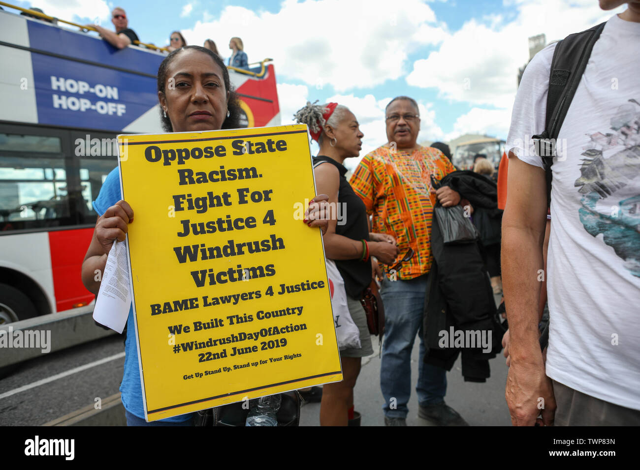 Westminster Bridge, London, UK. 22nd June, 2019. A banner drop from Westminster Bridge as part of the National Windrush Day of Action calling for justice and full compensation for victims of the Windrush scandal. Credit: Penelope Barritt/Alamy Live News Stock Photo