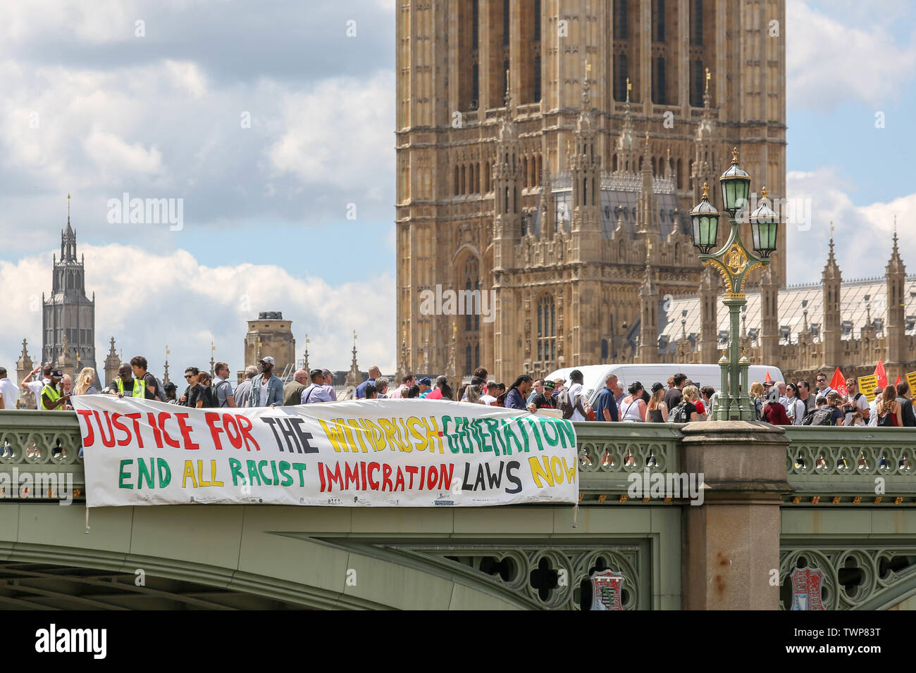 Westminster Bridge, London, UK. 22nd June, 2019. A banner drop from Westminster Bridge as part of the National Windrush Day of Action calling for justice and full compensation for victims of the Windrush scandal. Credit: Penelope Barritt/Alamy Live News Stock Photo