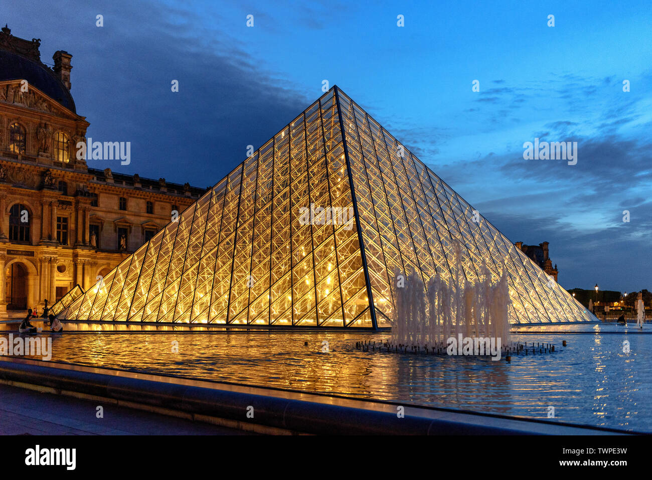 The illuminated glass pyramid at the Louvre Museum in Paris, France at dusk  Stock Photo - Alamy