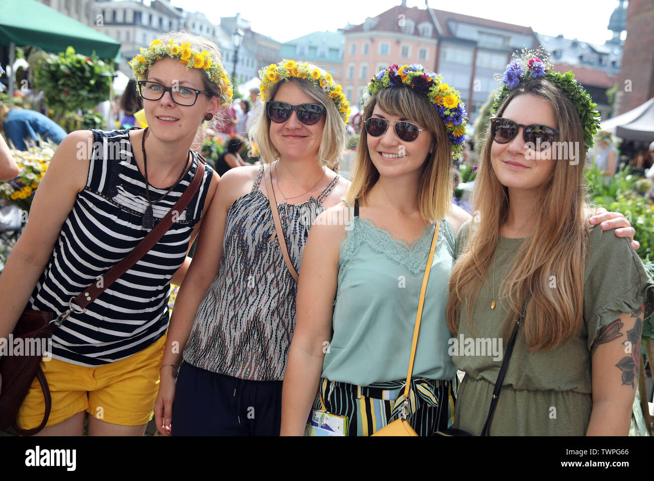 Riga, Latvia. 21st June, 2019. Women wearing flower crowns pose for photos  during the Midsummer festival Ligo market in Riga, Latvia, June 21, 2019.  The annual Midsummer festival Ligo market opened here