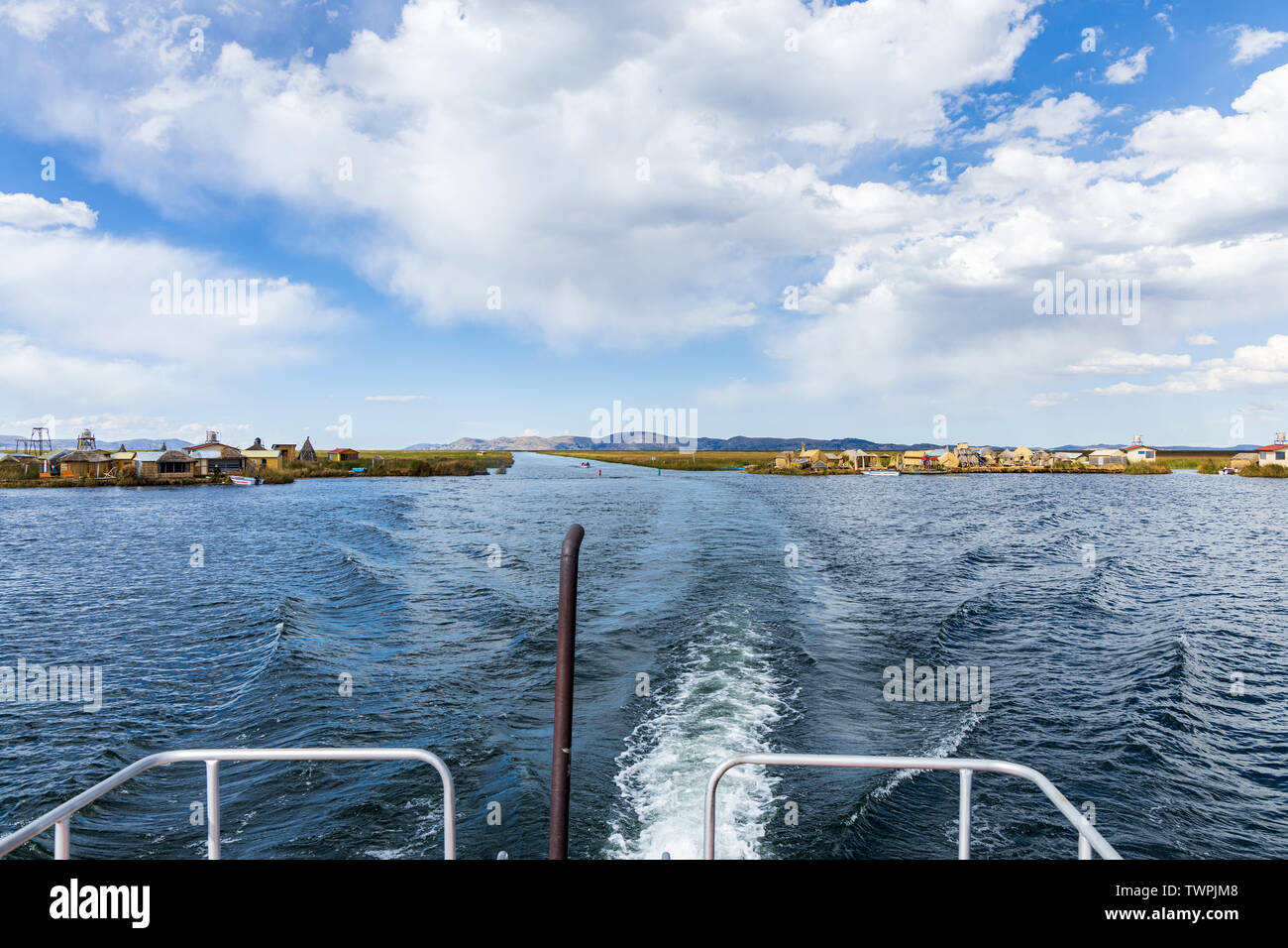 Travelling on a boat through a channel in the totora reeds on Lake Titicaca, Peru, South America Stock Photo