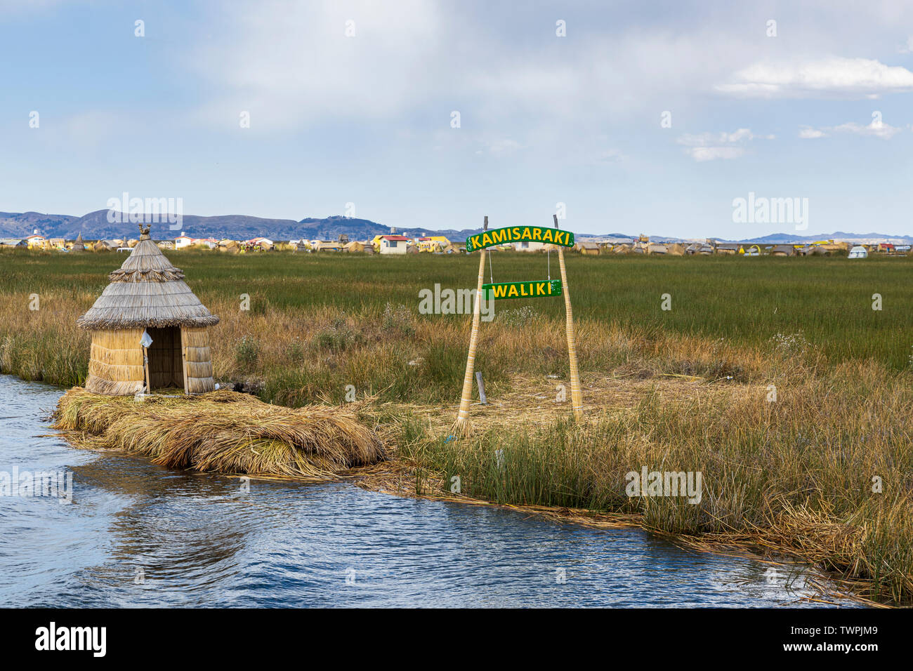 Boating through the reeds and floating villages of Uros islands on Lake Titicaca, Peru, South America Stock Photo