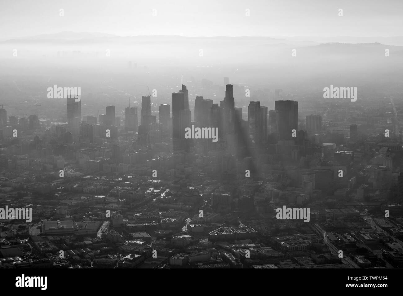 Aerial black and white view of thick summer smog in urban downtown Los Angeles, California. Stock Photo