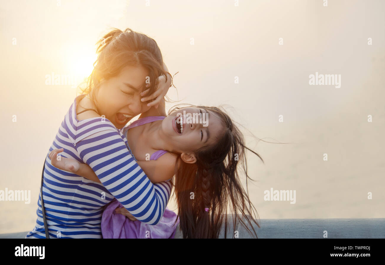 beautiful moment with mom and kid play and hug with sunset warm light. love together family Stock Photo