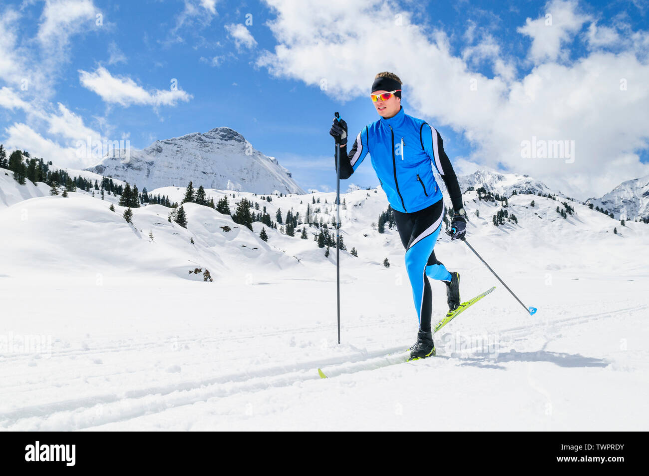 Couple during cross-country skiing exercise in classical style in austrian mountains near Warth Stock Photo