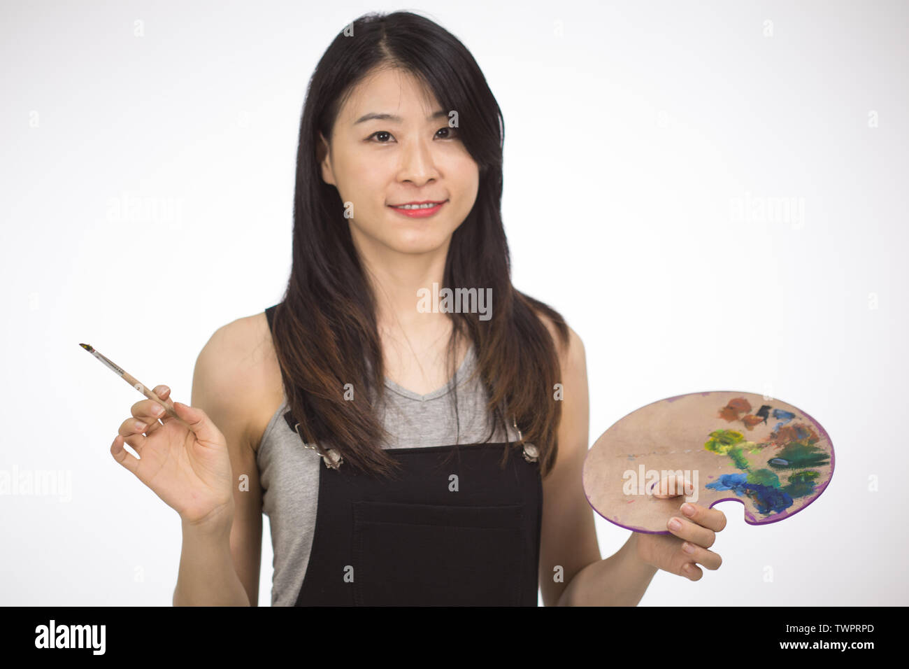 Artist holding painting palette and brush Stock Photo Alamy
