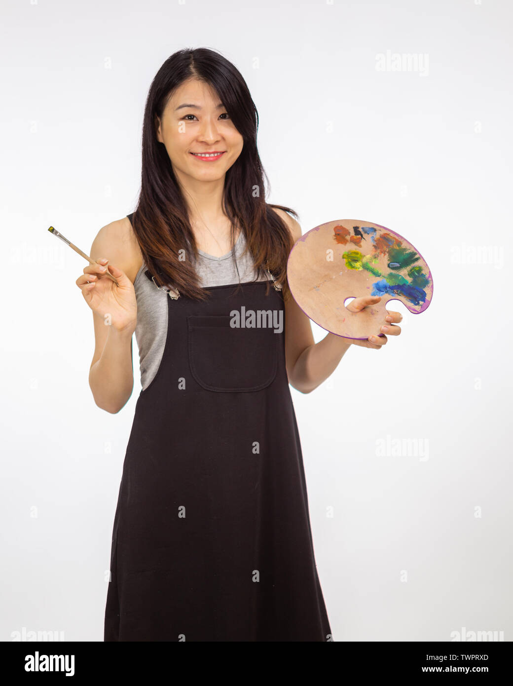 Artist holding painting palette and brush Stock Photo Alamy