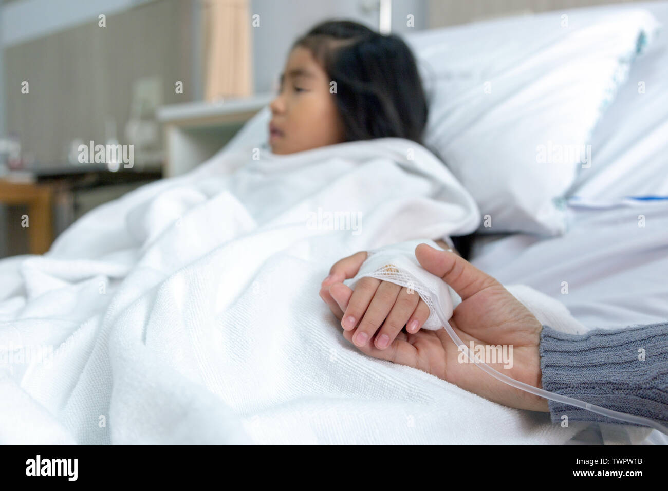 parent hold patient kid to give encouragement and injection hand for