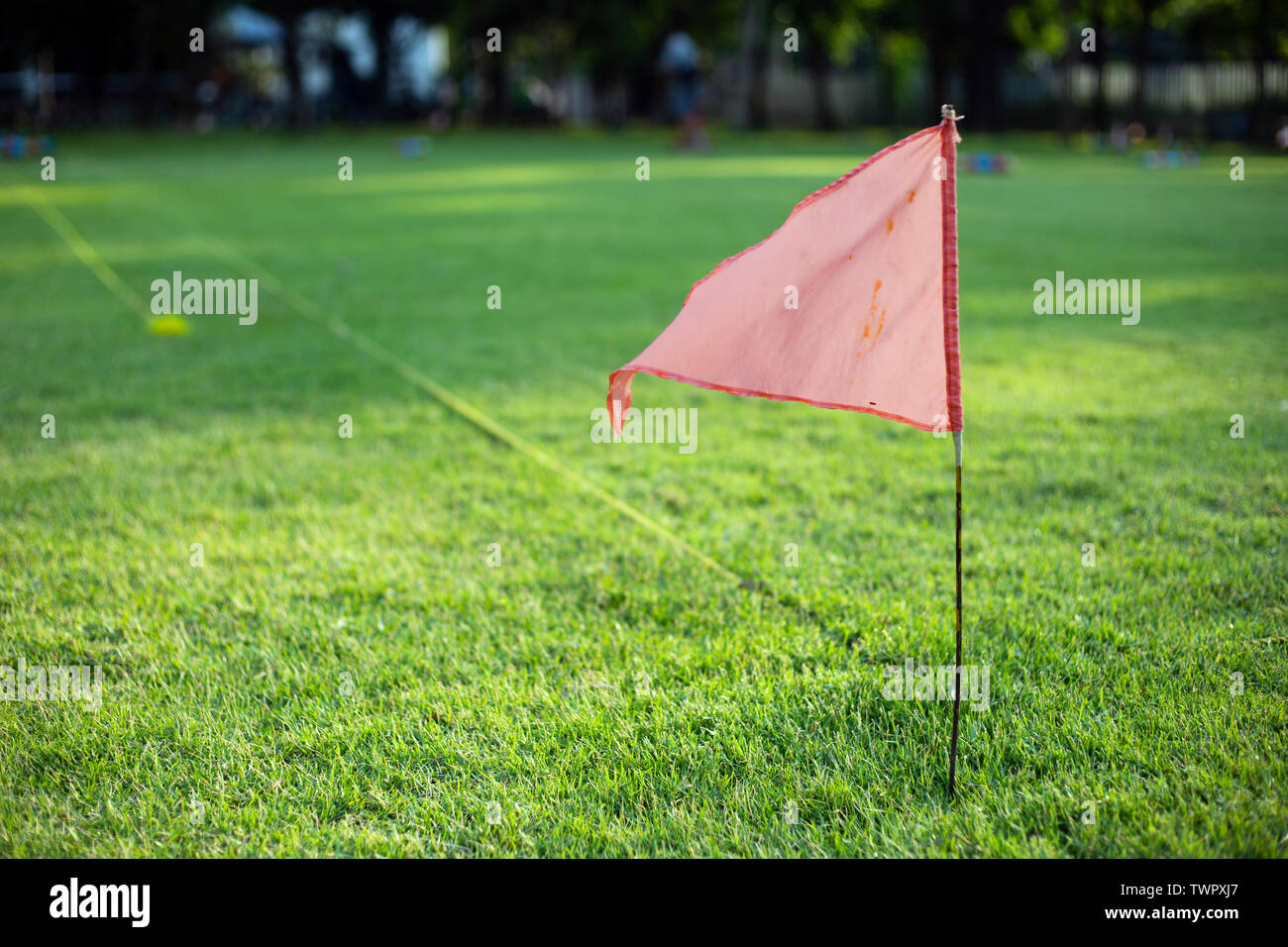 red flag on green grass outdoor sport game Stock Photo