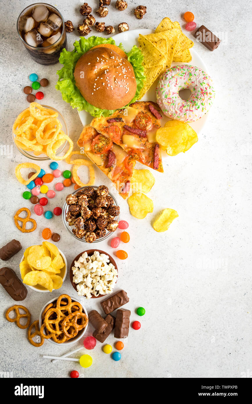 Assortment of Unhealthy Food, top view, copy space. Unhealthy eating, junk food concept. Stock Photo