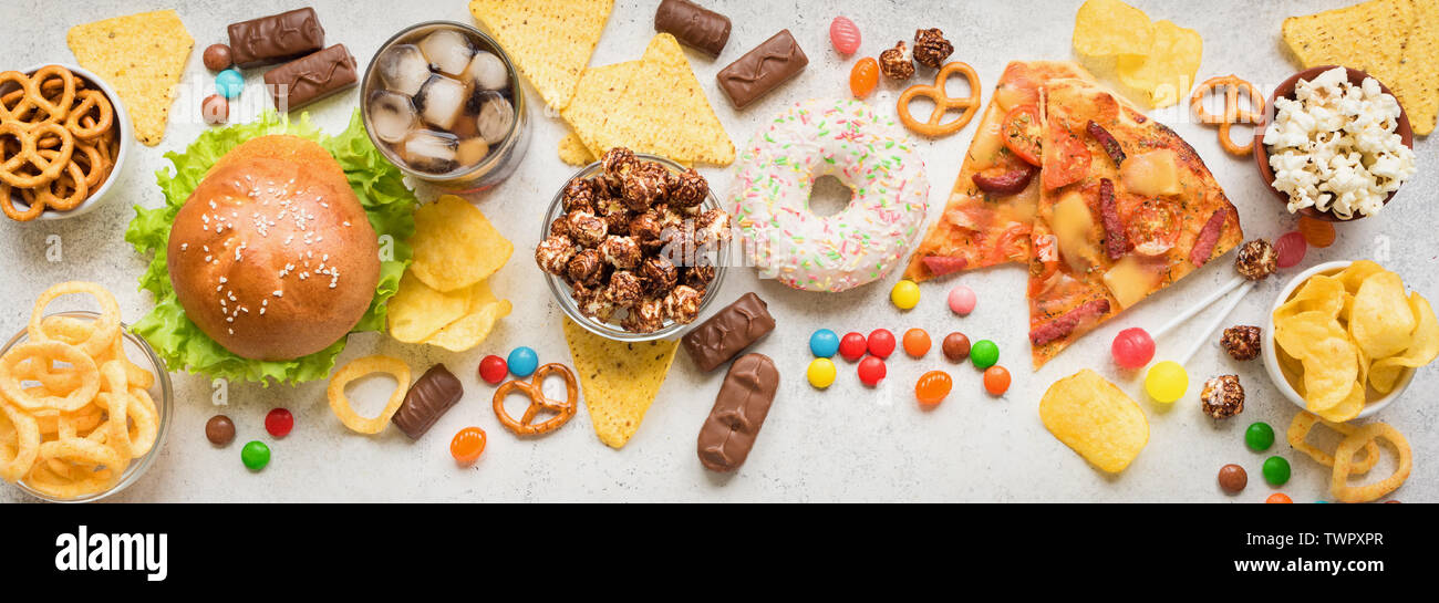 Assortment of Unhealthy Food, top view, banner. Unhealthy eating, junk food concept. Stock Photo