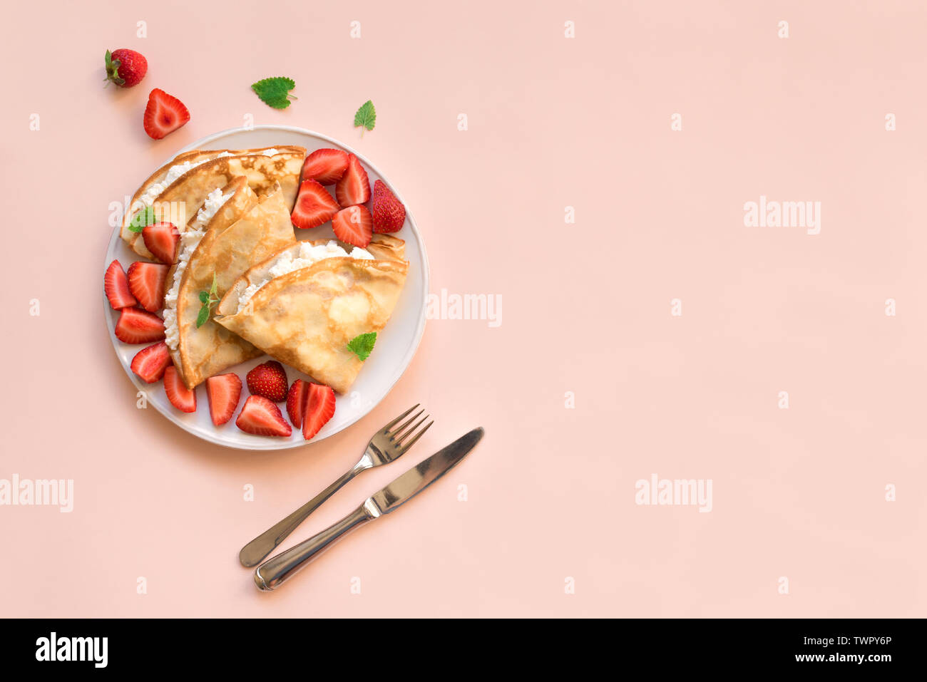 Crepes with ricotta cheese and fresh strawberries on pink pastel  background, top view, copy space. Delicious crepes, thin pancakes Stock  Photo - Alamy