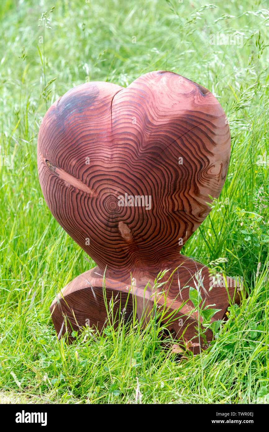Carved wooden heart at Daylesford Organic farm summer festival. Daylesford, Cotswolds, Gloucestershire, England Stock Photo