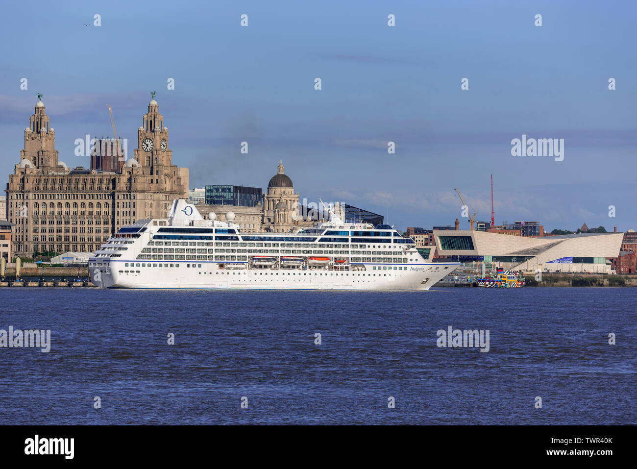 Invicta cruise ship. in the river Mersey at Liverpool pierhead. The Royal Liver building. left and the Museum of LIverpool right. Stock Photo