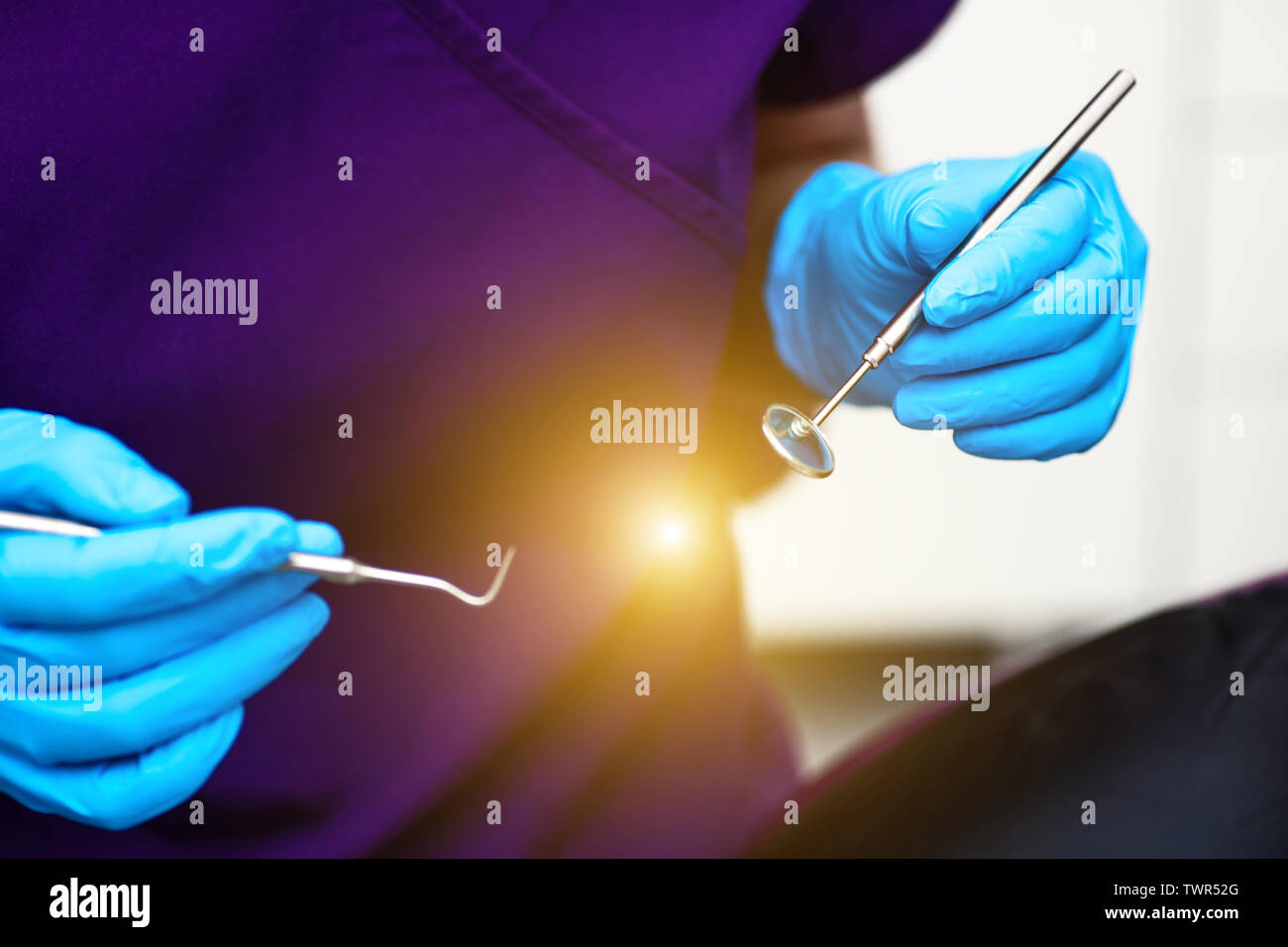 In the office of the dental clinic. The doctor holds tools for ...