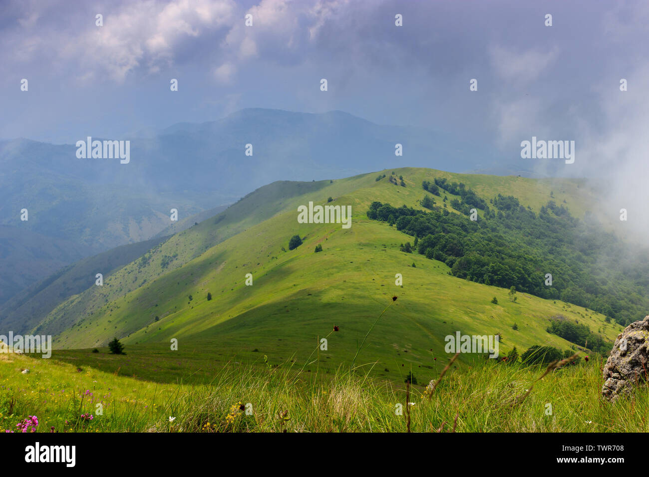 Beautiful view of green hills and mountain and blue sky Stock Photo