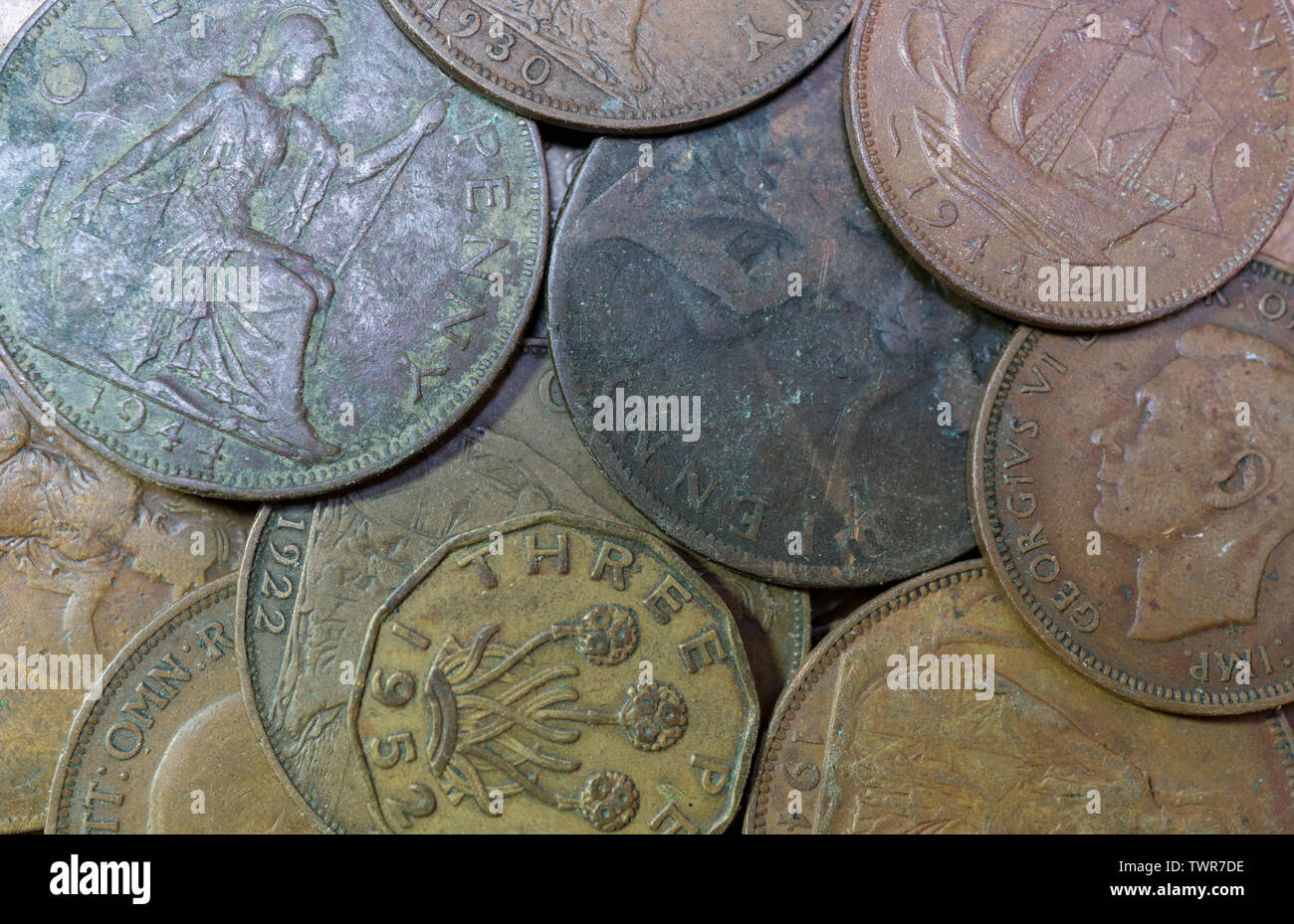 Old British coins, one penny coins. threepenny bit,halfpenny and sixpence. British Isles. Stock Photo