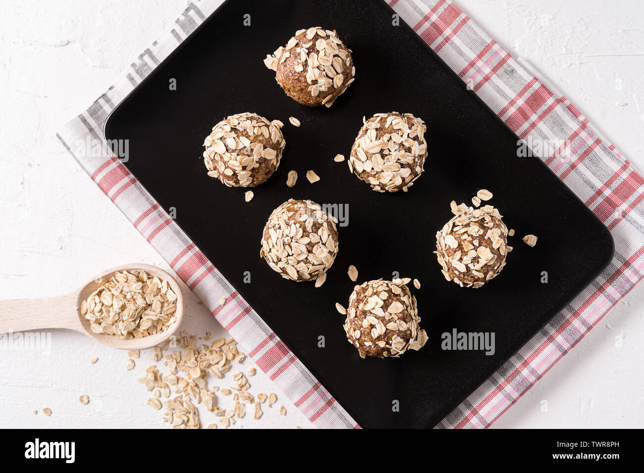 Healthy organic energy balls made with dates, oat flakes, dried cranberries, pecan nuts, in