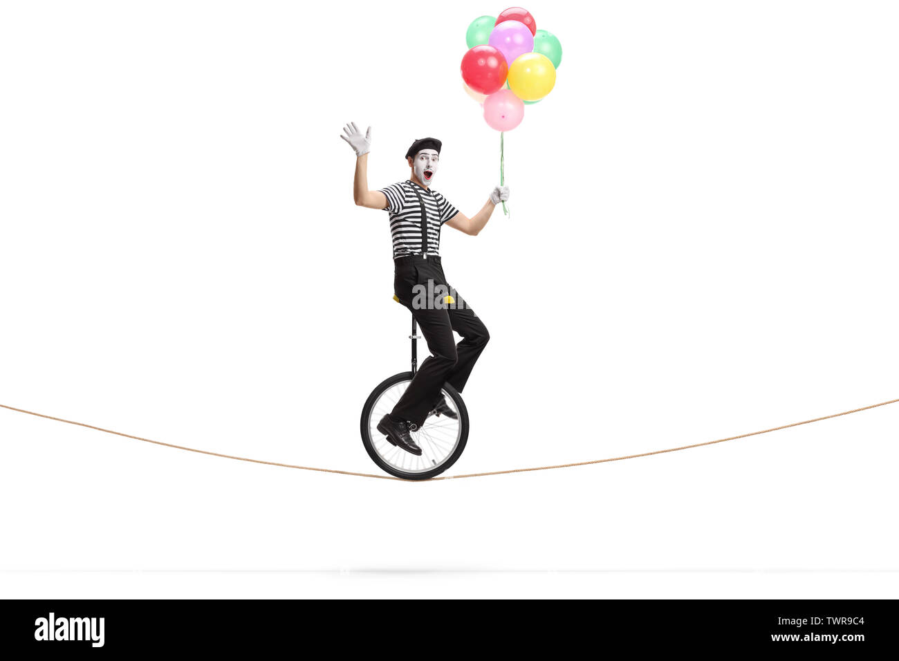 Full length shot of a mime riding a unicycle on a rope, holding a bunch ...