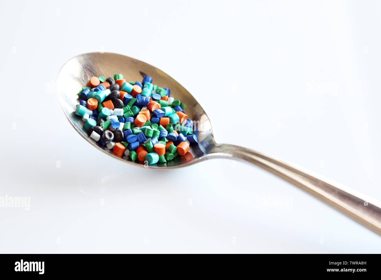 A spoon full of plastic granules. Indicates how much plastic we eat