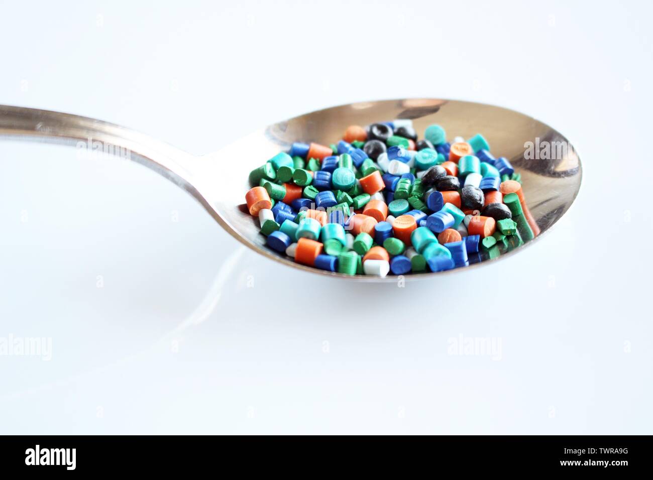 A spoon full of plastic granules. Indicates how much plastic we eat